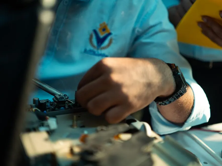 A detailed close-up of a technician working on machinery, highlighting skill and precision.
